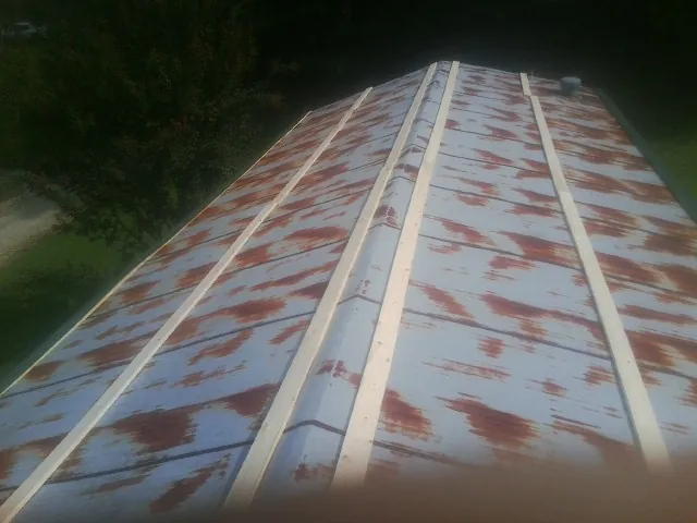 Rusted metal roof panels with new wood purlins before replacement — Storm Damage Roof Repair in Polaris by Roofing Brothers